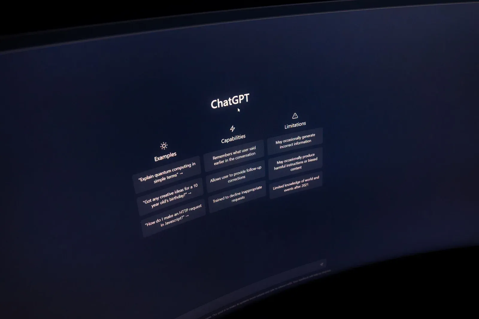 Close-up of a computer screen displaying ChatGPT interface in a dark setting.