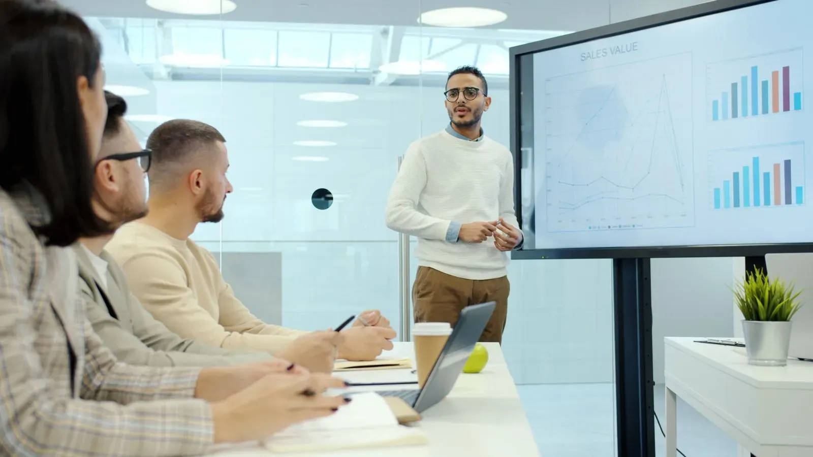 Marketing and sales team reviewing a revenue presentation